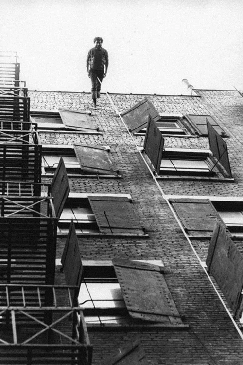 Man Walking Down the Side of a Building постер